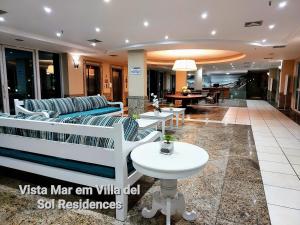a lobby with a couch and a table at Vista Mar em Villa del Sol Residences - unidade autônoma in Rio de Janeiro