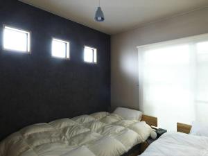 Letto o letti in una camera di Renewal Open! 【urban’s camp fuji】ウッドデッキでBBQ可！新装別荘！