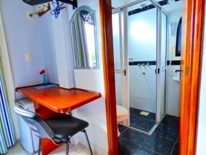 bagno con scrivania rossa e servizi igienici di De La Costa Hotel a Encarnación
