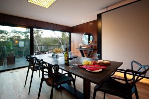 a dining room with a table with a plate of food on it at Harmony in Hepburn Springs