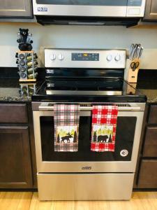 a stove in a kitchen with two towels on it at Riverside Cabin 2 in Grants Pass