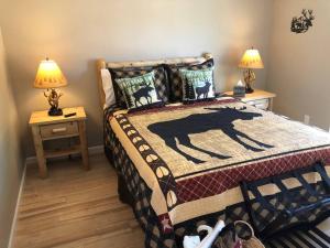 a bedroom with a bed with a horse blanket on it at Riverside Cabin 2 in Grants Pass