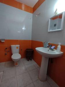 a bathroom with a toilet and a sink at Apartment suitable for families in Imouzzer du Kandar