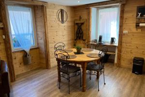 a wooden dining room with a table and chairs at La Dorbluche apartment 4-6 person in Longefoy