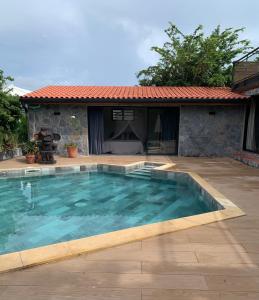 a swimming pool in front of a house at Héritage créole 4 - Mazurka in Sainte-Luce