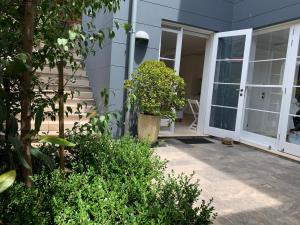 a house with an open door with a plant at Balmoral Salt in Sydney