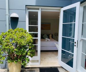 an open door to a patio with a bedroom at Balmoral Salt in Sydney