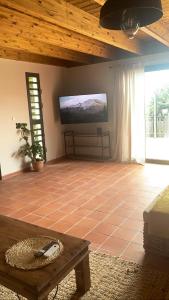 a living room with a flat screen tv on the wall at Héritage créole 4 - Mazurka in Sainte-Luce