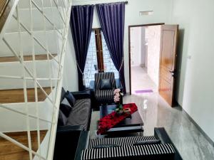 a living room with a couch and a table at Wafaby Guest House in Payakumbuh