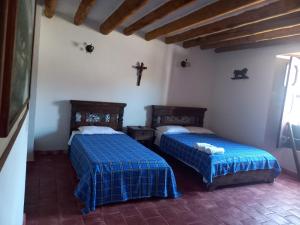 En eller flere senge i et værelse på Los recuerdos de Carmen