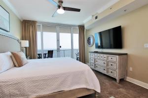 a bedroom with a bed and a flat screen tv at San Carlos 1205 in Gulf Shores