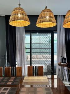 a dining room with a table and chairs and lights at 17 Riada Villa in San Juan