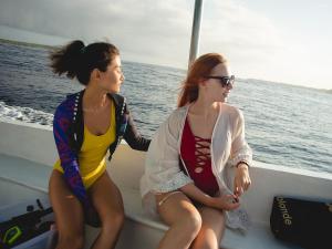 two women sitting on a boat in the water at Seven Angels Villa and Hostel in Nusa Penida +2 photos