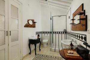 a bathroom with a toilet and a sink and a door at Puri Tempo Doeloe Boutique Hotel in Sanur