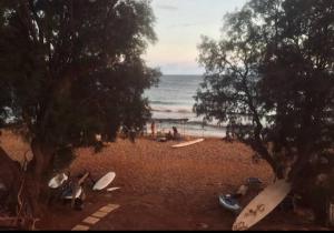 a group of surfboards sitting on the beach at All weather house in Elíka