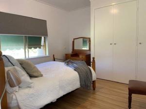 a bedroom with a bed and a dresser and a mirror at Eos 2 in Esperance