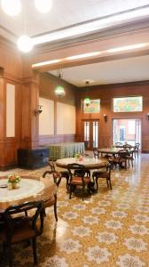 a large room with tables and chairs in it at Hotel Candi Baru in Jomblang