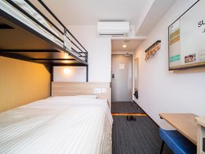 Postel nebo postele na pokoji v ubytování Super Hotel Yahaba Station East Exit