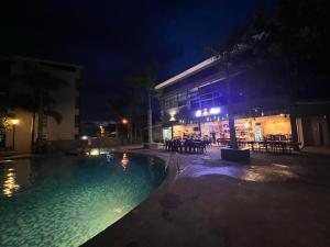 a swimming pool in front of a building at night at SDC Suite Home in Lahad Datu