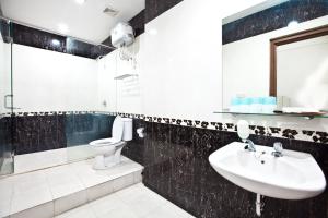 y baño con lavabo y aseo. en Hotel Candi Baru, en Jomblang