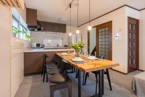 a kitchen and dining room with a wooden table and chairs at My Retreat Osaka in Osaka