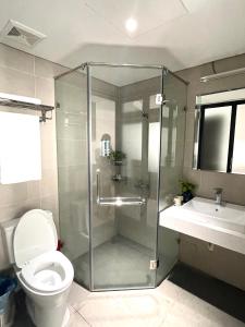 La salle de bains est pourvue d'une douche, de toilettes et d'un lavabo. dans l'établissement Kem Apart 01, à Hanoï