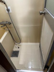 a bathroom with a bath tub with a shower stall at Convenient Apartment in Otsuka in Tokyo