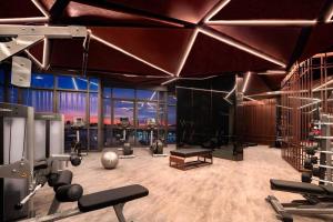 a gym with weights and equipment in a room at Edge Central Pattaya BJ in Pattaya Central