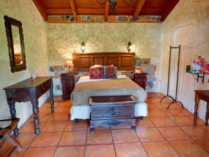 a bedroom with a bed and a desk in it at Naif Boutique Hotel in Antigua Guatemala