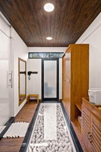 a bathroom with a shower with a pebble floor at Vijayshree Resort, Hampi in Hampi