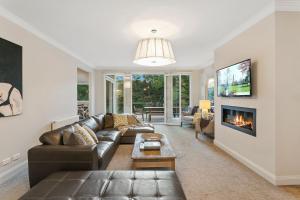 a living room with a couch and a fireplace at Lakes Edge in Daylesford