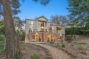 a house on a hill with a tree at Lakes Edge in Daylesford