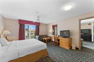 a hotel room with a bed and a television at Scottsdale 2 bd 2 ba furnished apt King beds in Scottsdale