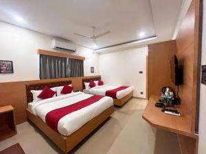 a hotel room with two beds and a television at AIR VALLEY INN in Guwahati