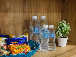 three bottles of water and snacks on a table at Valley Suites by WyattHomes in Kuantan