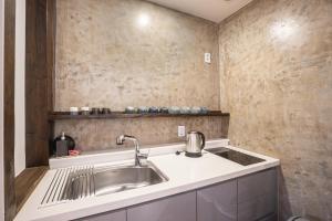 a kitchen with a sink and a counter at Olle Resort & SPA in Jeju