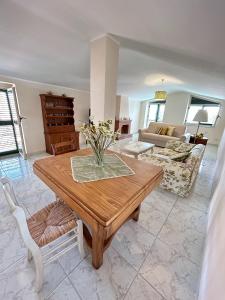 a living room with a table and a couch at Casa Dambrosio vacation Breathtaking views in Camerota +6 photos