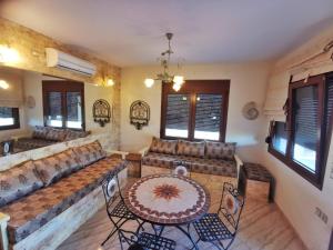 a living room with a couch and a table and chairs at Villa Elli in Alexandroupoli