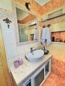 a bathroom with a sink and a mirror at Villa Elli in Alexandroupoli