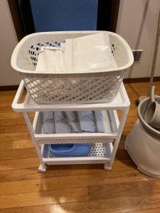 a white rack with dishes in it on a floor at FOREST HOUSE in Kusatsu