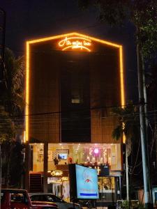 a building with a sign on top of it at night at AIR VALLEY INN in Guwahati