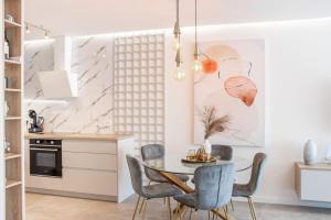 a kitchen and dining room with a table and chairs at Apartment Ladan in Trogir