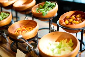 a display of bowls of food on a table at TIAD, Autograph Collection in Nagoya