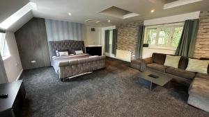 a living room with a bed and a couch at Peaceful LARGE Studio Flat Colchester in Colchester