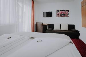 Łóżko lub łóżka w pokoju w obiekcie Sporthotel Kitz inkl Sommercard, kostenlose Maut für die Großglockner Hochalpenstraße, zentrale Lage mit bestem Ausblick