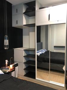 a bedroom with a bunk bed and a mirror at Cozy Room, Study Space & Bathtub in Manila
