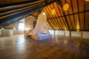 a bedroom with a canopy bed in a attic at Shakti Villa Umalas in Canggu