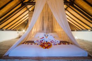 a bedroom with a bed with a mosquito net at Shakti Villa Canggu in Canggu