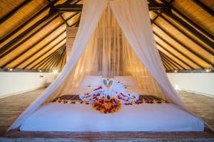 a bedroom with a bed with a mosquito net at Shakti Villa Umalas in Canggu
