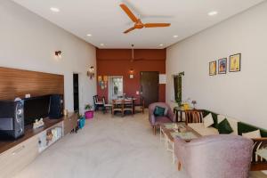a living room with a couch and a tv at Par-X Mist View 9A Garden Villa 3BHK in Lonavala